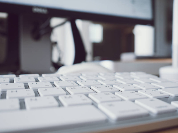 Close up image of keyboard on wooden office work desk. - Фото, зображення