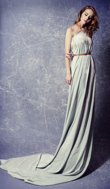 Beautiful woman posing in a long dress - Фото, изображение