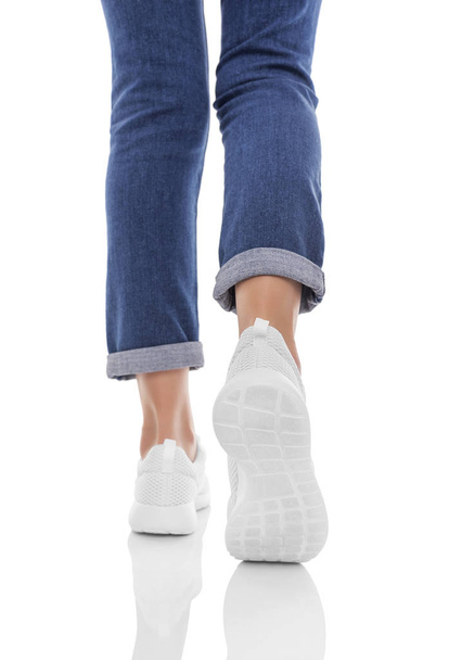 Female feet in sneakers. Do step. - Foto, immagini