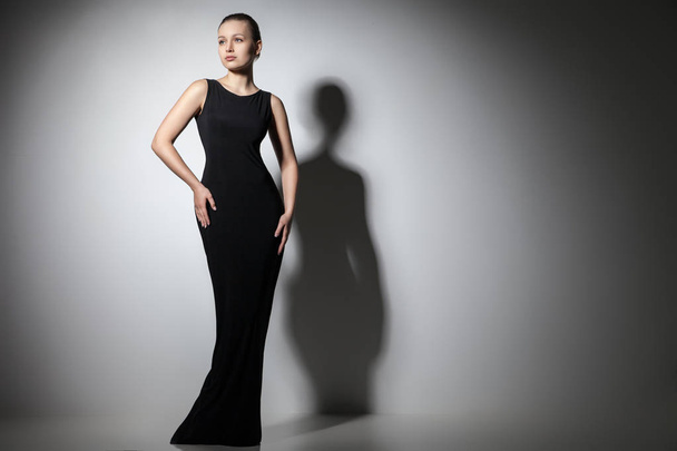 beautiful woman model posing in elegant black dress - Photo, image