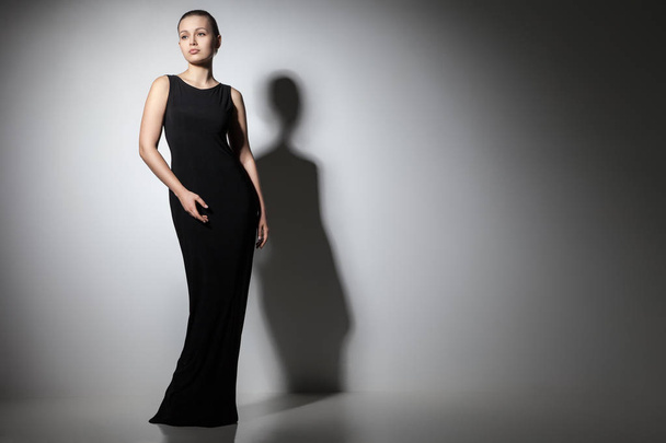 beautiful woman model posing in elegant black dress - Фото, зображення