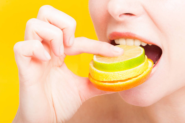 Close-up of female mouth eating fresh fruits - Fotografie, Obrázek