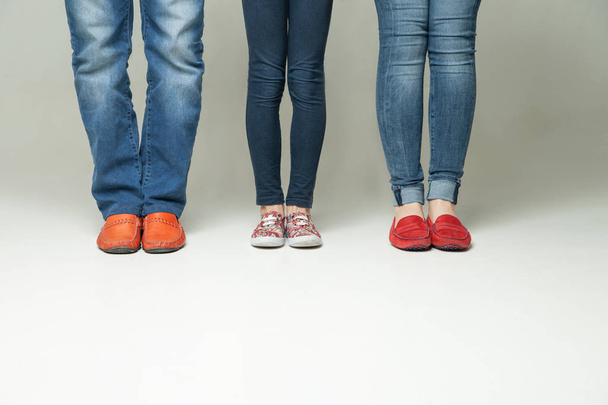barefoot  legs of mother, father and little child wearing  jeans - 写真・画像