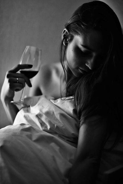 woman holding glass of wine - Фото, изображение