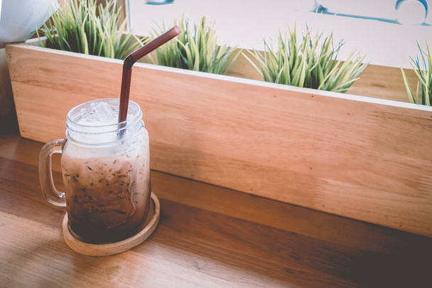 warm vintage concept : cool cappuccino coffee cup in cafe shop - Фото, изображение