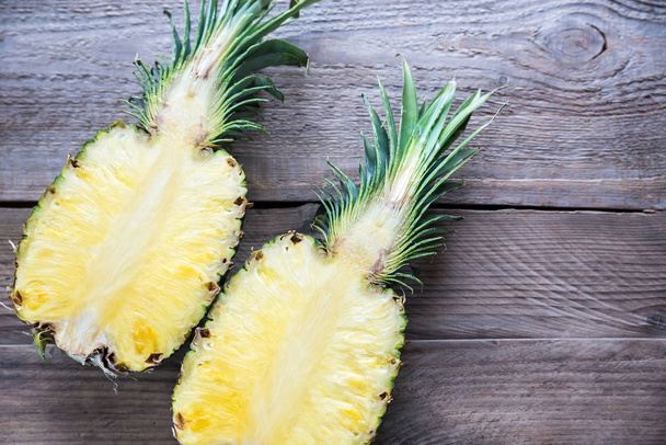 Pineapple on the wooden background: cross section - Photo, Image
