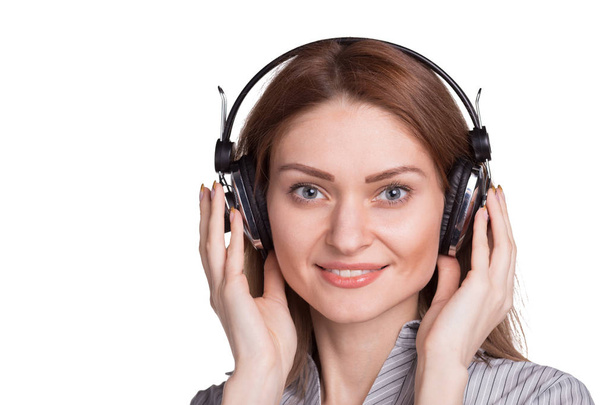 Pretty woman listening to music via headphones - Photo, image