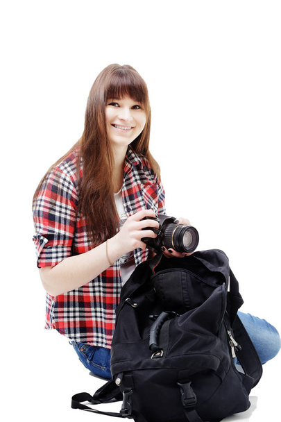 Travel concept. Full length studio portrait of pretty young woman holding camera. Isolated on white. - Photo, Image