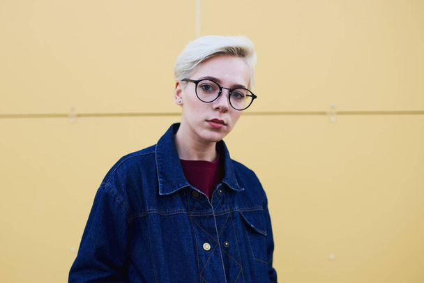  Girl hipster with trendy eyewear looking into camera standing on urban  - Valokuva, kuva