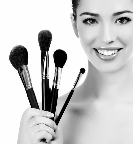 Woman with cosmetic brushes - Fotoğraf, Görsel