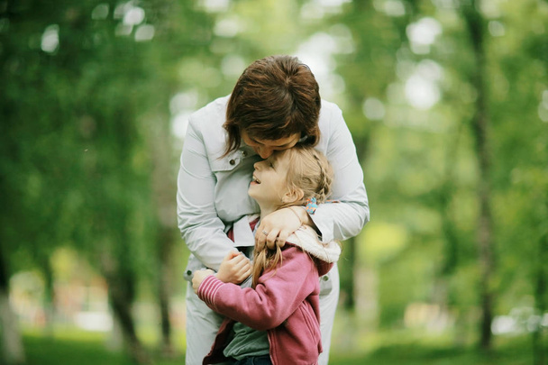 Mother and daughter in summer park - Foto, immagini