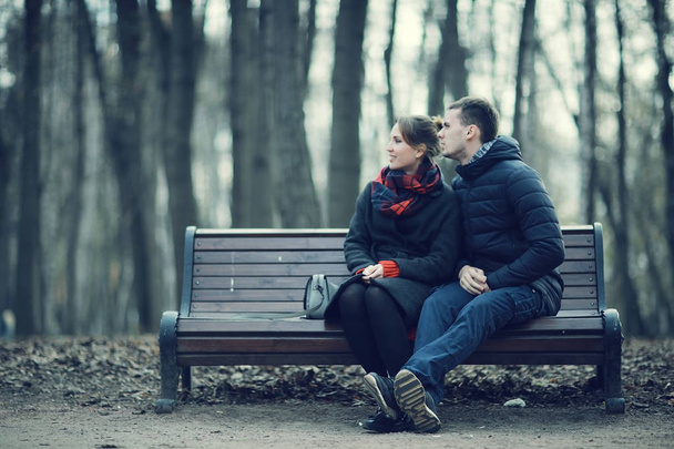 Couple sitting on a bench - Fotó, kép