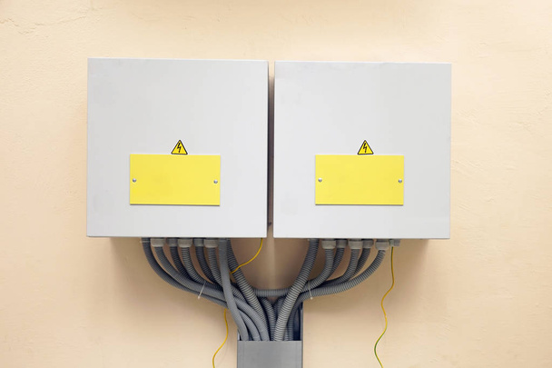 Two boxes with electrical equipment and electric cables. - Photo, Image