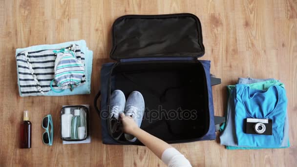 hands packing travel bag with personal stuff - Video, Çekim