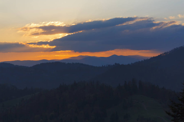 Dramatic orange sunset in the mountains. Carpathians - 写真・画像