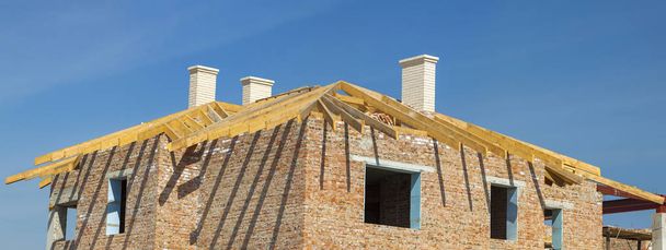 Roofing Construction. Wooden Roof Frame, White Chimneys and Yell - Photo, Image