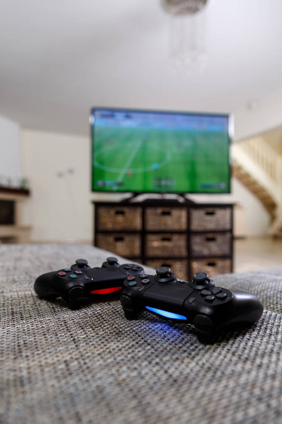 Playing video game. Console controllers. - 写真・画像