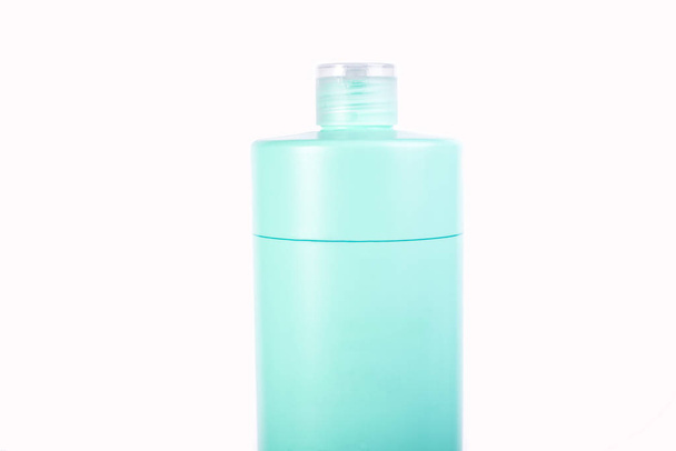 Blue cosmetic bottle closeup, personal care isolated on a white background. - Photo, Image