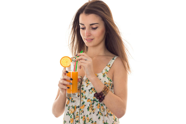 a young girl holds orange juice - Fotó, kép