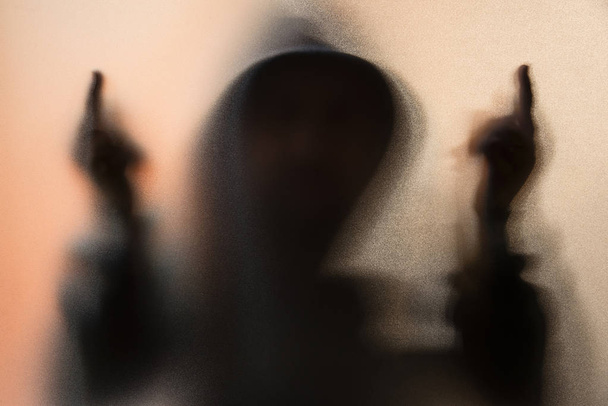 Shadow blur of horror man in jacket with hood.Middle finger symb - Fotó, kép