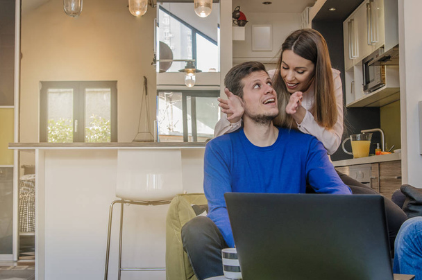 Happy couple doing business together working at small office at home, Portrait of a cheerful woman hugging man from behind  - Fotoğraf, Görsel