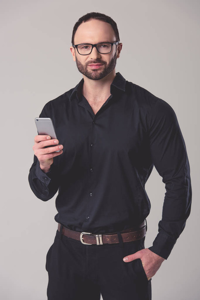 Handsome businessman with gadget - Zdjęcie, obraz