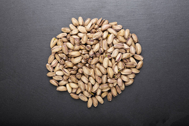 pistachios on a slate, a top view - Photo, image