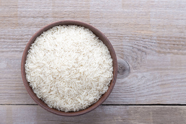 rice on a wooden background - Zdjęcie, obraz