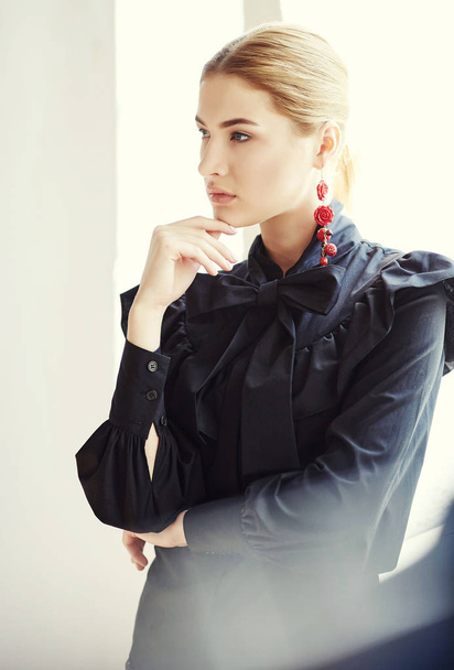 Blonde female dressed in a black apparel - Фото, зображення