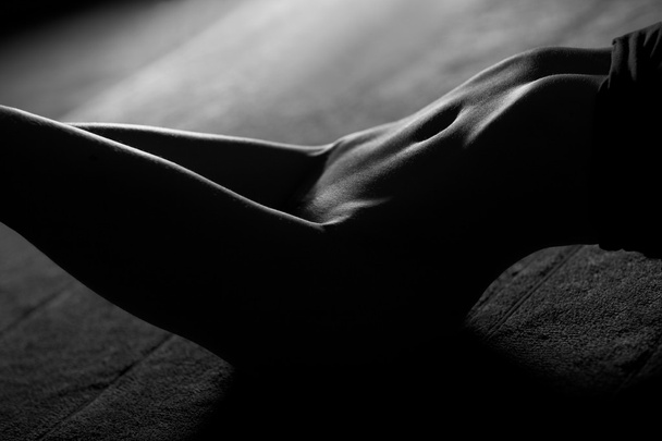 Sexy, erotic woman lays on floor - 写真・画像