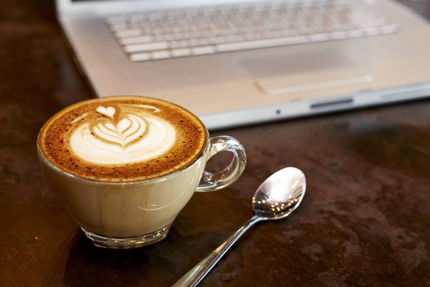 laptop with fresh cup of coffee  - 写真・画像