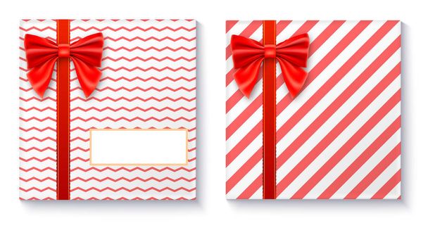 Gift boxes with big red bow and ribbon on white background. - Vektör, Görsel