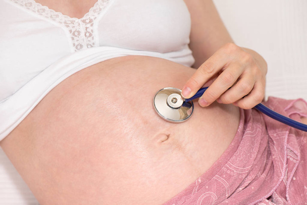 Pregnant woman with stethoscope - Photo, Image