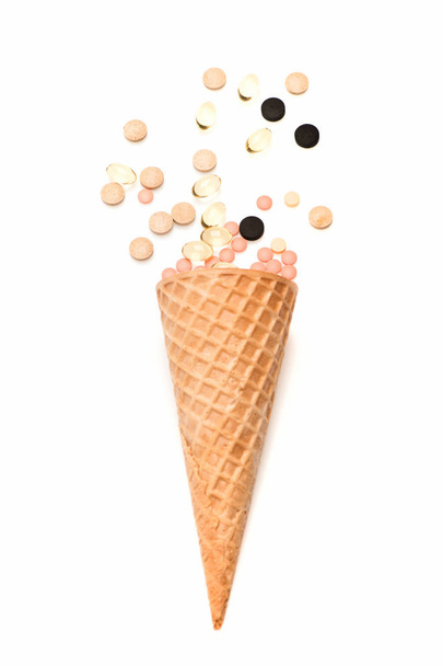 pills, drug capsule in waffle cone isolated on white background - Photo, image