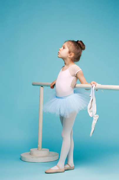 The little balerina dancer on blue background - Valokuva, kuva
