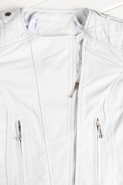 White leather jacket on white background. Leather jacket macro details - Foto, immagini