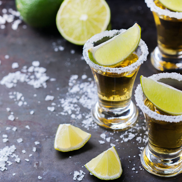 Golden mexican tequila shot with green lime and salt - Photo, Image