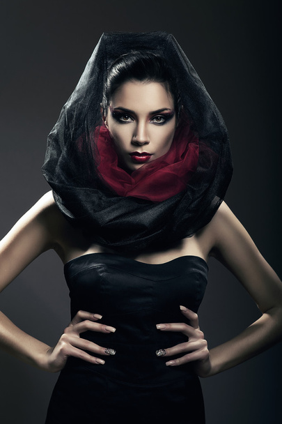 hot mysterious woman in black hood in dark - 写真・画像