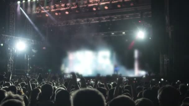 Lights flashing on illuminated stage, audience watching show, enjoying music - Footage, Video