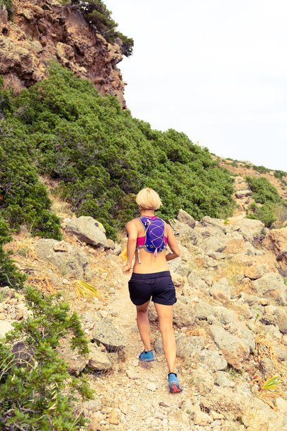 Happy woman trail running in beautiful mountains - Fotoğraf, Görsel