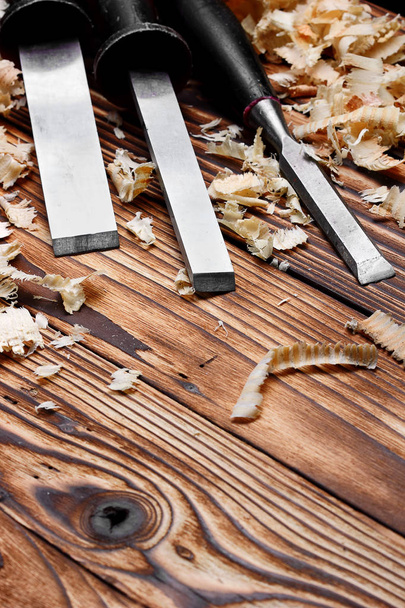 Woodworking tools. Chisel with sawdust .copy space.vertical shot - Fotó, kép