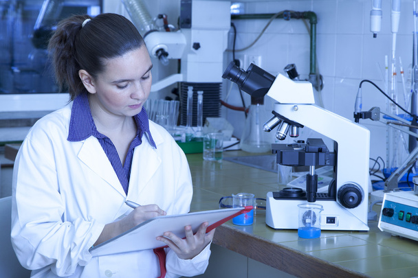 Cute chemist working in laboratory - Фото, изображение