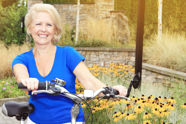 Senior lady on a bike - Photo, Image