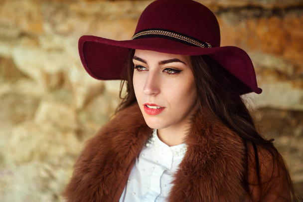 portrait of a beautiful girl in the hat on a mountain background - Photo, image