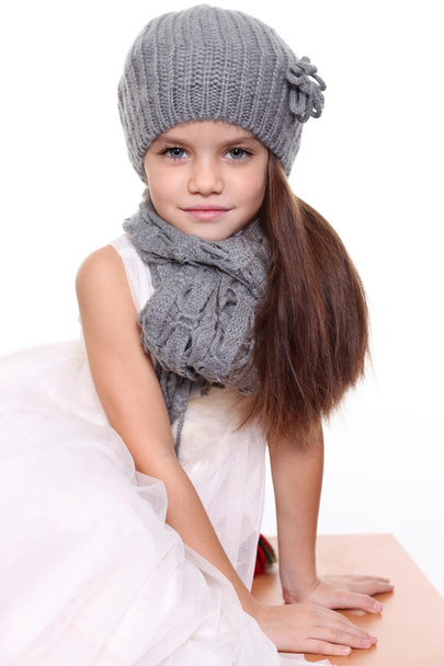 little girl in a knitted hat and gray scarf - Foto, imagen