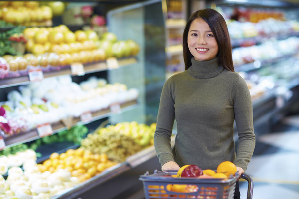 Young Asian Woman Shopping in the Supermarket - Fotó, kép