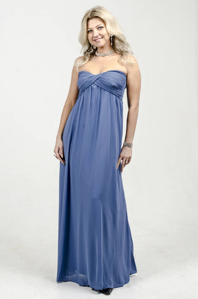 Beautiful blonde woman in a blue cocktail dress - Zdjęcie, obraz