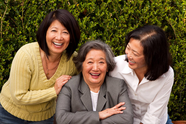 Mature Asian mother and her adult daughters. - Photo, image