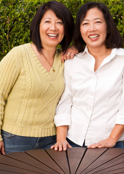 Mature Asian sisters smiling and laughing. - Photo, Image