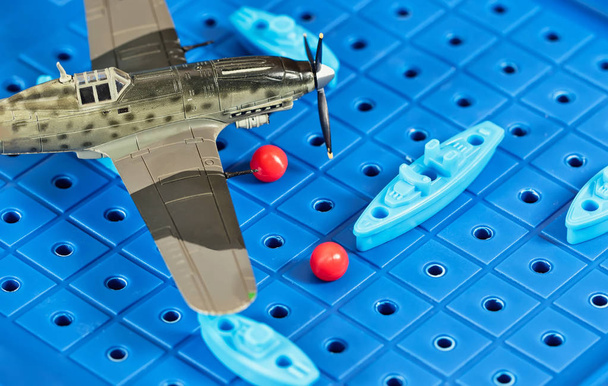 Toy military airplane is attacking toy ships  - Photo, Image